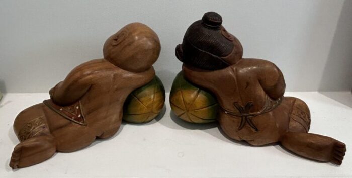 1980s carved and painted asian wood carvings of sleeping children on melons set of 2 5700