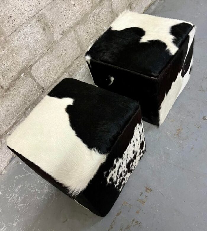 a pair of late 20th century cow hide ottomans footstools 3149