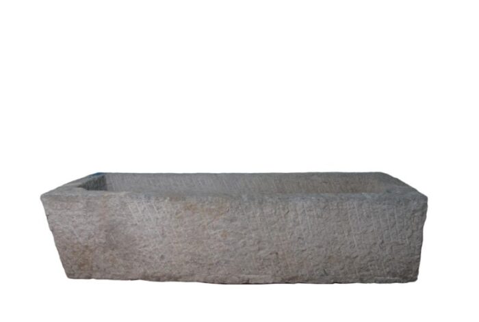 antique long hand chiseled stone trough 1662