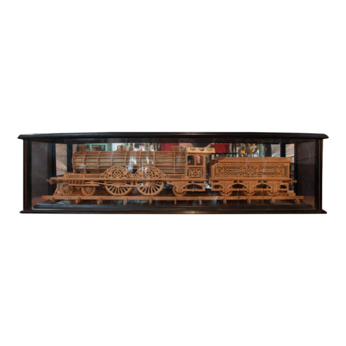 carved wood model of a locomotive in black lacquered and glass case 5698