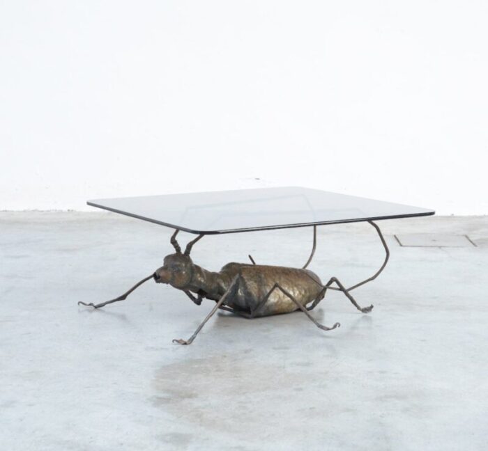 coffee table with a handcrafted metal cricket sculpture base 1970s 1