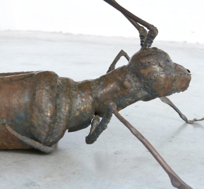 coffee table with a handcrafted metal cricket sculpture base 1970s 3