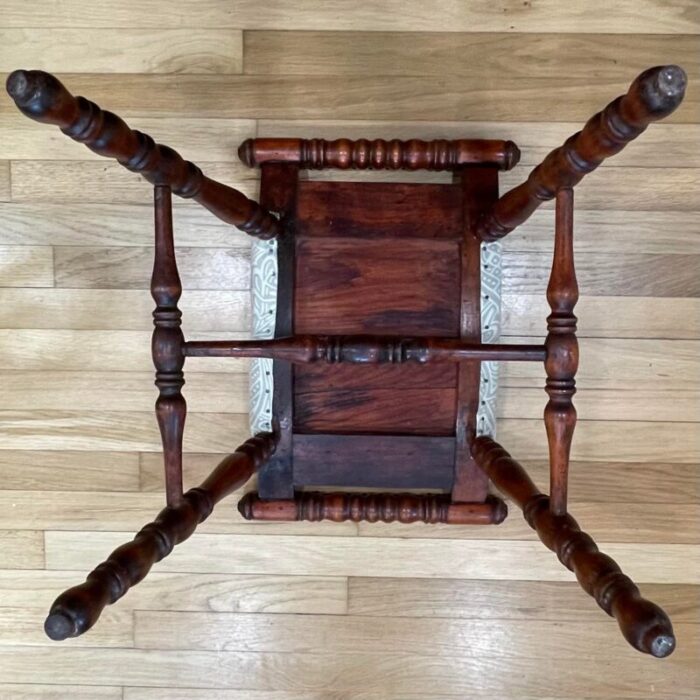 early 20th century traditional victorian spooled footstool with abstract beige upholstery 9378